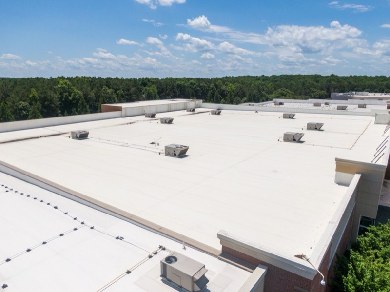 large flat commercial roof with rooftop units, seen from above