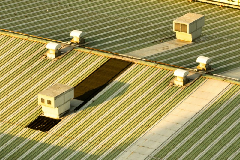 inspector recording findings on a flat commercial roof